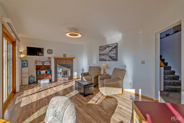 living room featuring hardwood / wood-style floors and a wood stove