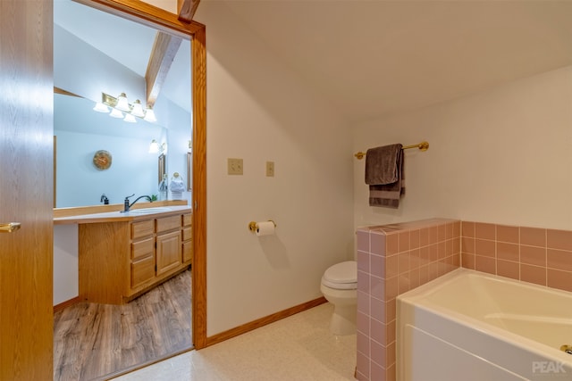 bathroom with a bathtub, vanity, hardwood / wood-style flooring, toilet, and lofted ceiling