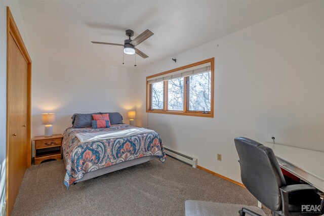 carpeted bedroom with a baseboard heating unit, ceiling fan, and a closet