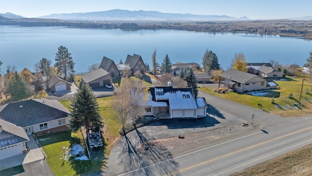 drone / aerial view featuring a water and mountain view