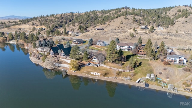 birds eye view of property with a water and mountain view