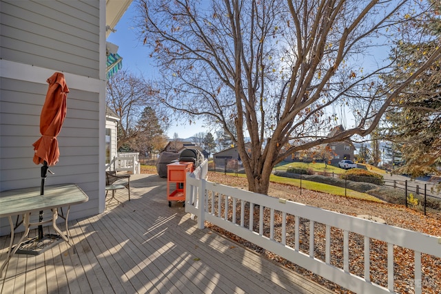 wooden deck featuring a storage shed