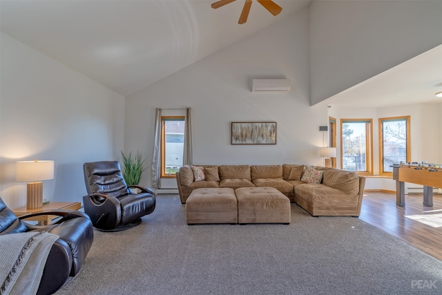 living room with a wall unit AC, hardwood / wood-style flooring, ceiling fan, and high vaulted ceiling