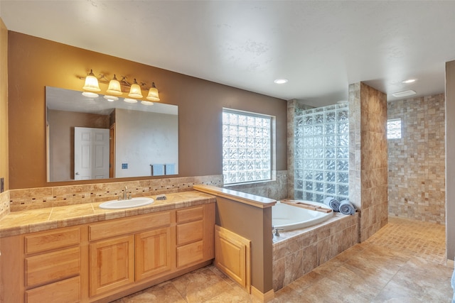 bathroom with vanity, tile patterned floors, and shower with separate bathtub