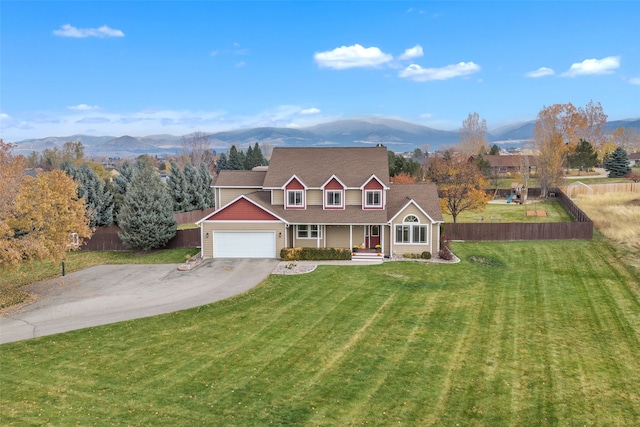 view of front of property with a mountain view, a garage, a front yard, and covered porch