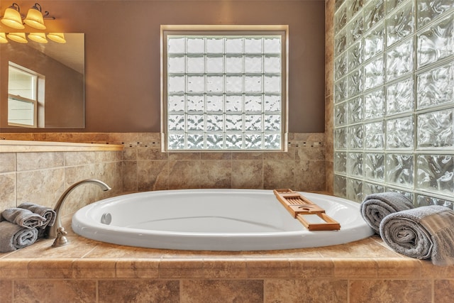 bathroom featuring tiled tub