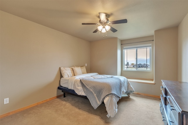 bedroom with ceiling fan and light colored carpet