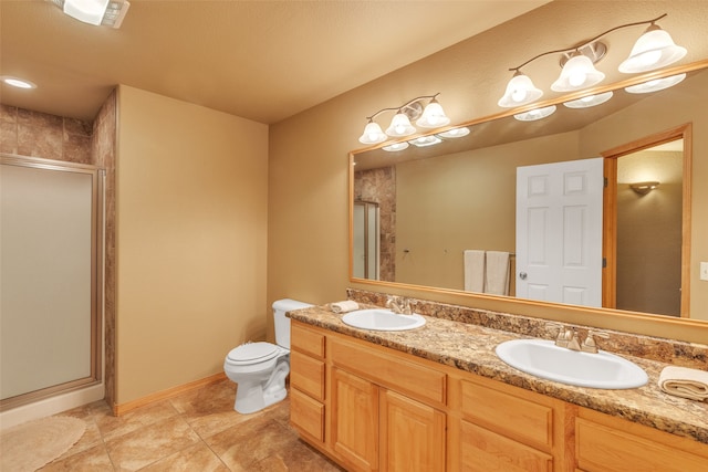 bathroom featuring toilet, vanity, an enclosed shower, and tile patterned floors