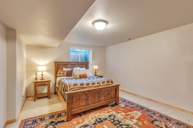 carpeted bedroom featuring a textured ceiling