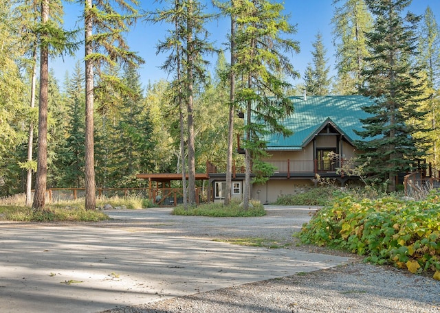 exterior space featuring metal roof and decorative driveway