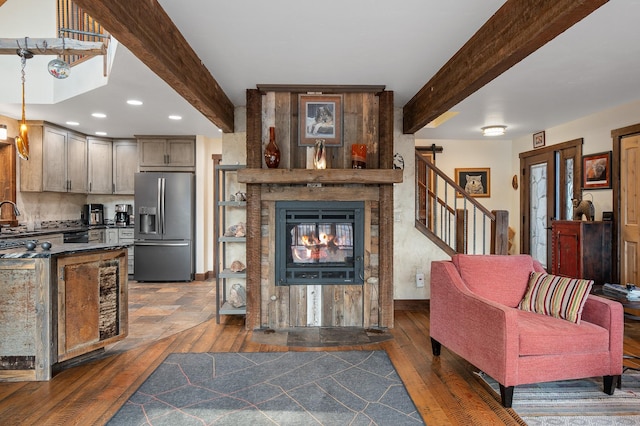 living area featuring dark wood-style floors, a multi sided fireplace, beam ceiling, and baseboards