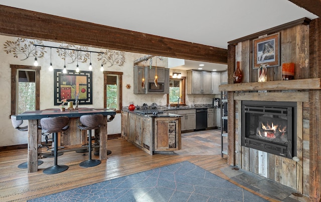 bar with a sink, hanging light fixtures, dishwasher, stainless steel microwave, and dark wood finished floors