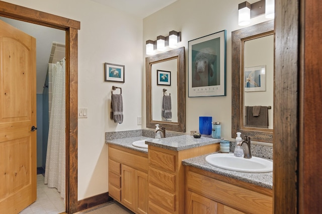 full bathroom with vanity and baseboards