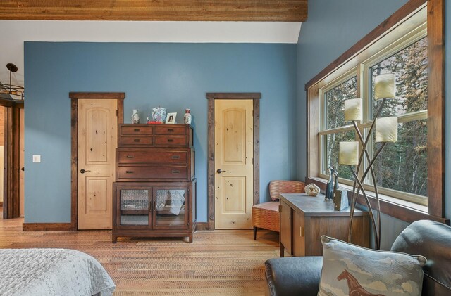 bedroom with light wood-type flooring and baseboards