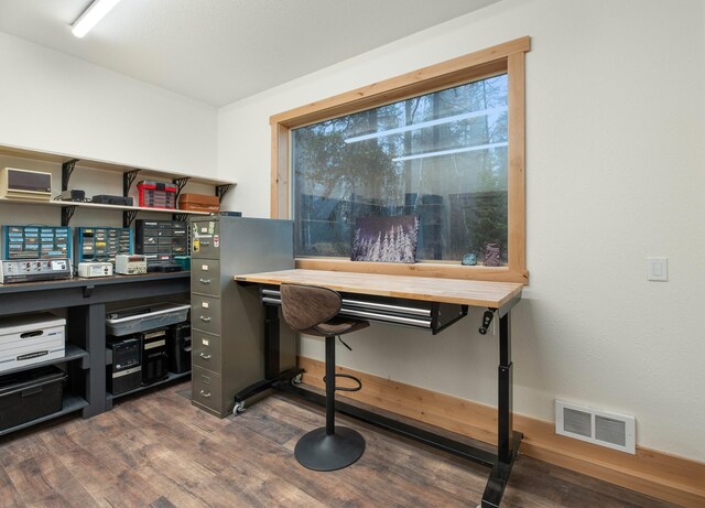 home office with dark wood-type flooring and visible vents