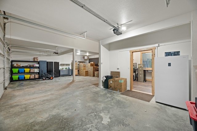 garage featuring freestanding refrigerator and a garage door opener