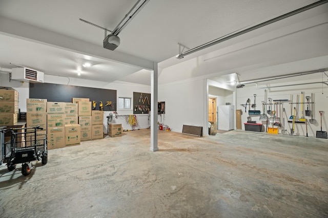 garage with a garage door opener and freestanding refrigerator