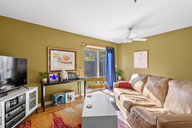 living room featuring ceiling fan and light wood-type flooring