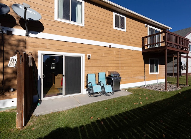 rear view of property with a lawn, a patio, and a balcony