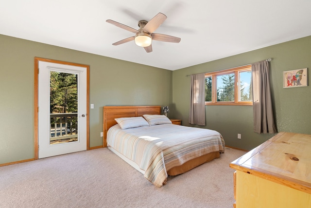 carpeted bedroom with multiple windows, ceiling fan, and access to exterior