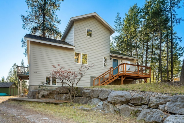 rear view of house with a wooden deck