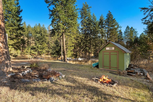 128 Ledgewood Dr, Bigfork, MT 59911 - view of yard with a shed and an outdoor fire pit