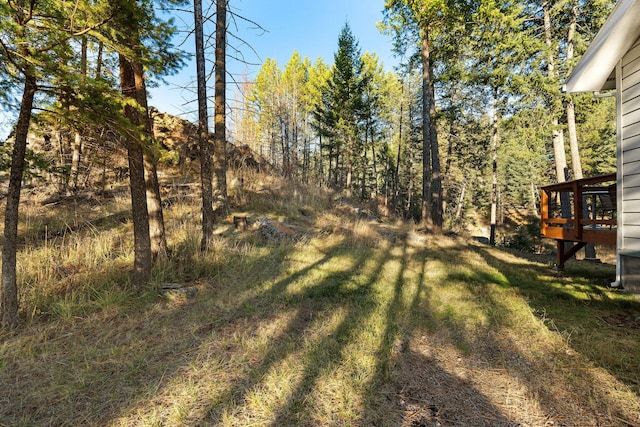 128 Ledgewood Dr, Bigfork, MT 59911 - view of green lawn featuring a wooden deck