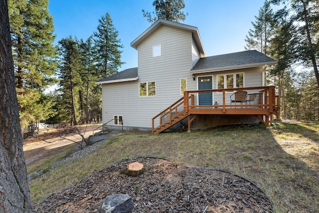128 Ledgewood Dr, Bigfork, MT 59911 - rear view of house featuring roof with shingles, a wooden deck, and stairs
