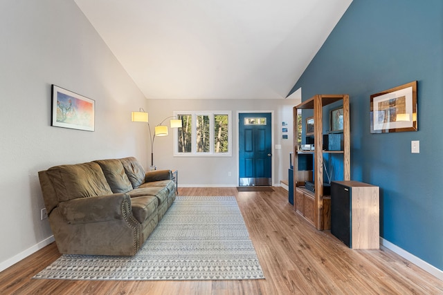 living room featuring high vaulted ceiling and light wood-type flooring