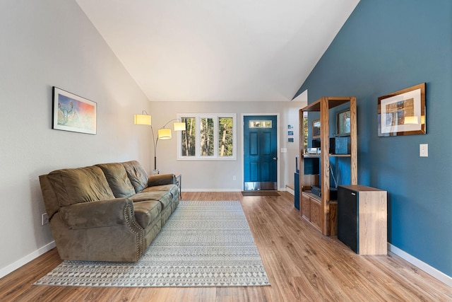 128 Ledgewood Dr, Bigfork, MT 59911 - living area featuring lofted ceiling and wood finished floors