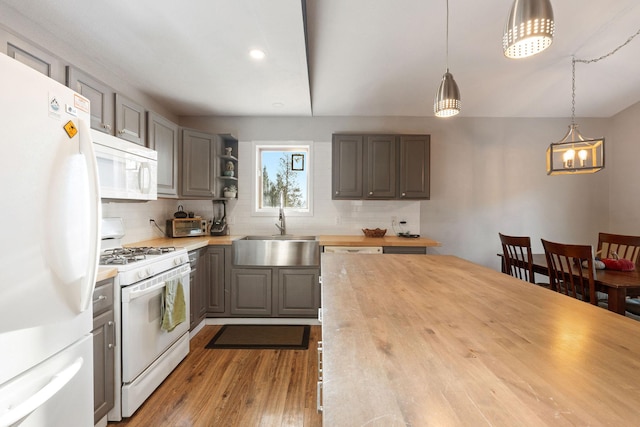 128 Ledgewood Dr, Bigfork, MT 59911 - kitchen featuring white appliances, butcher block countertops, decorative backsplash, wood finished floors, and gray cabinets