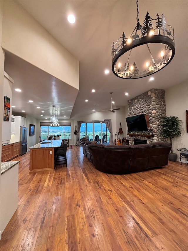 kitchen with a towering ceiling, a fireplace, and wood walls