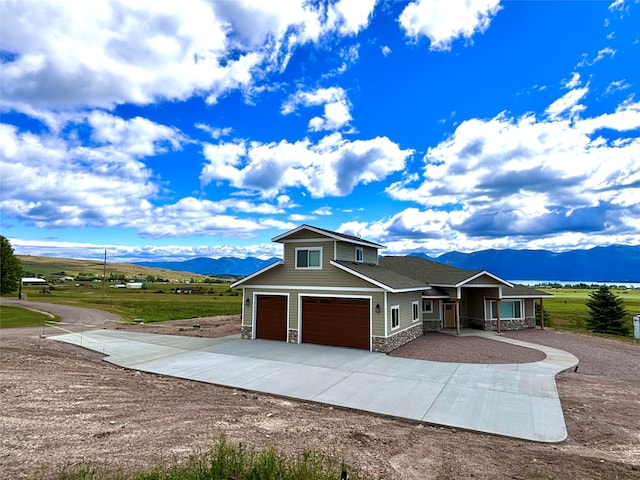 view of front of house with a garage, a mountain view, and a porch