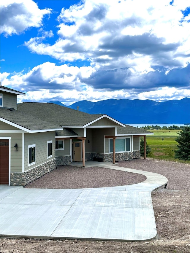 single story home with a mountain view and a garage