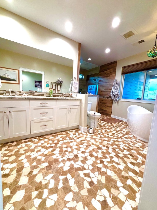 bathroom with wood walls, walk in shower, and vanity