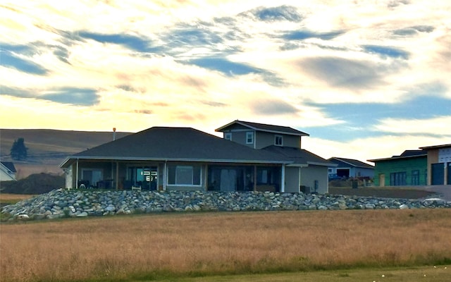 view of back house at dusk