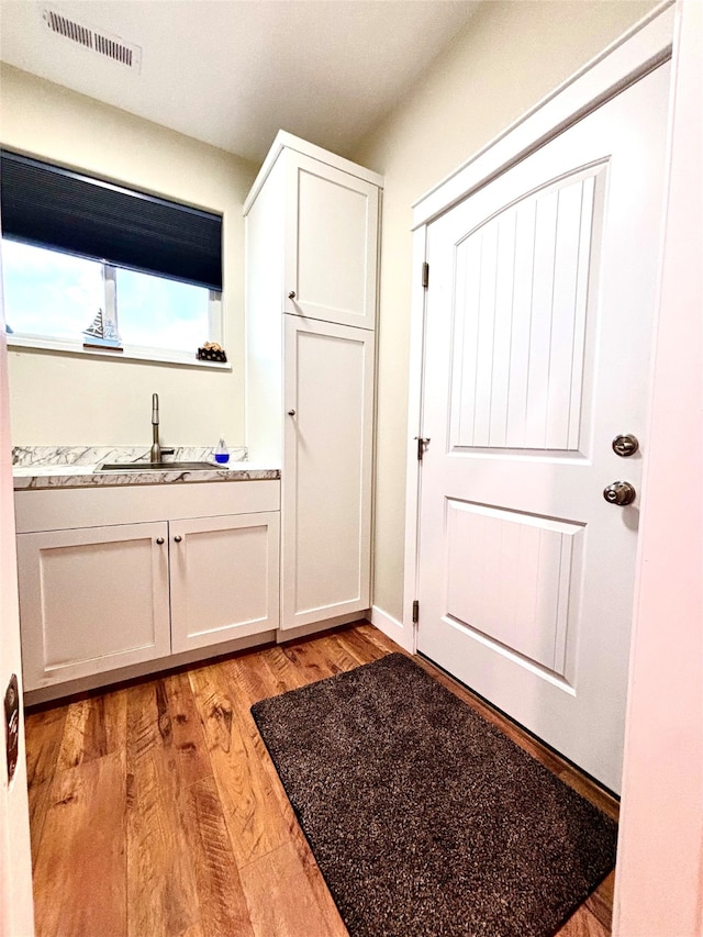 interior space with sink and light hardwood / wood-style floors