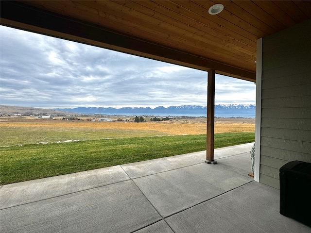 view of patio / terrace with a mountain view and a rural view