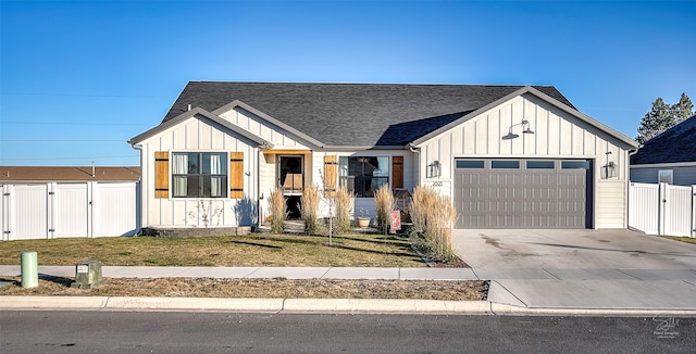 modern farmhouse style home featuring a garage and a front lawn