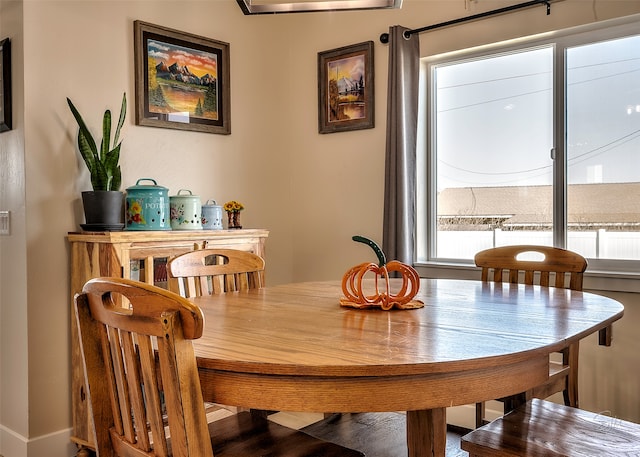 dining space with hardwood / wood-style flooring