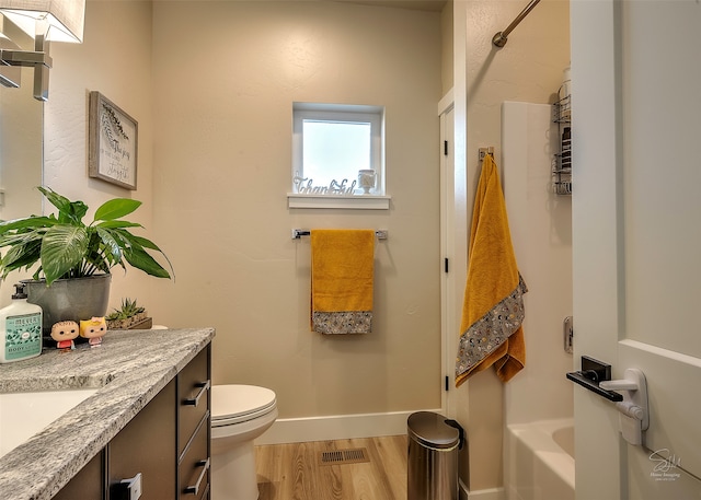 bathroom featuring toilet, vanity, and hardwood / wood-style flooring