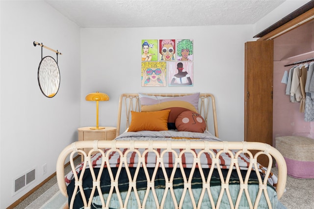 carpeted bedroom with visible vents and a textured ceiling