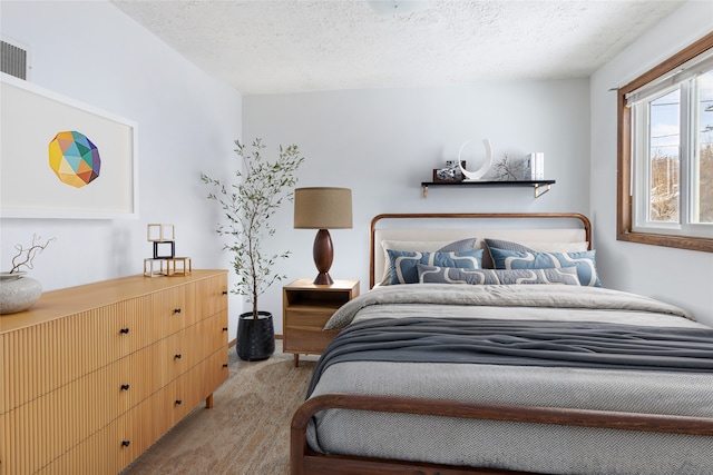 bedroom featuring carpet and a textured ceiling