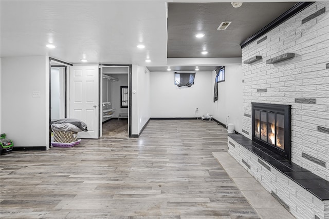 interior space featuring a fireplace and light hardwood / wood-style flooring