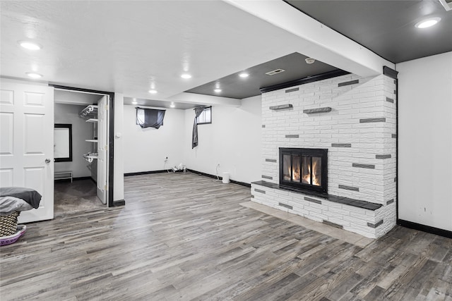 unfurnished living room featuring hardwood / wood-style floors and a fireplace