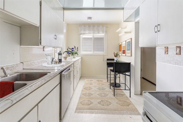 kitchen featuring light tile patterned floors, light countertops, stainless steel dishwasher, white cabinets, and a sink