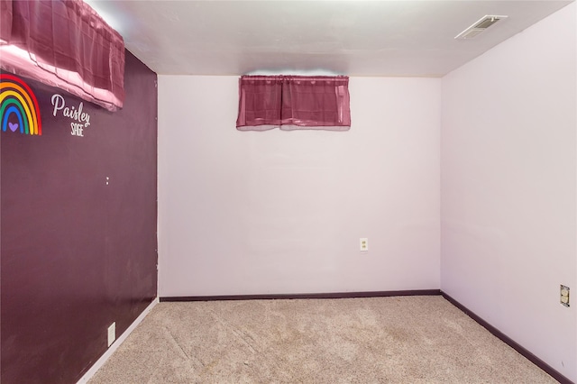 carpeted empty room featuring visible vents and baseboards