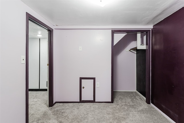 hallway featuring light colored carpet