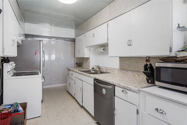 kitchen featuring white cabinets, appliances with stainless steel finishes, and sink