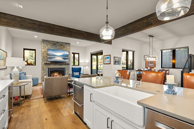 kitchen with white cabinets, a wealth of natural light, and pendant lighting